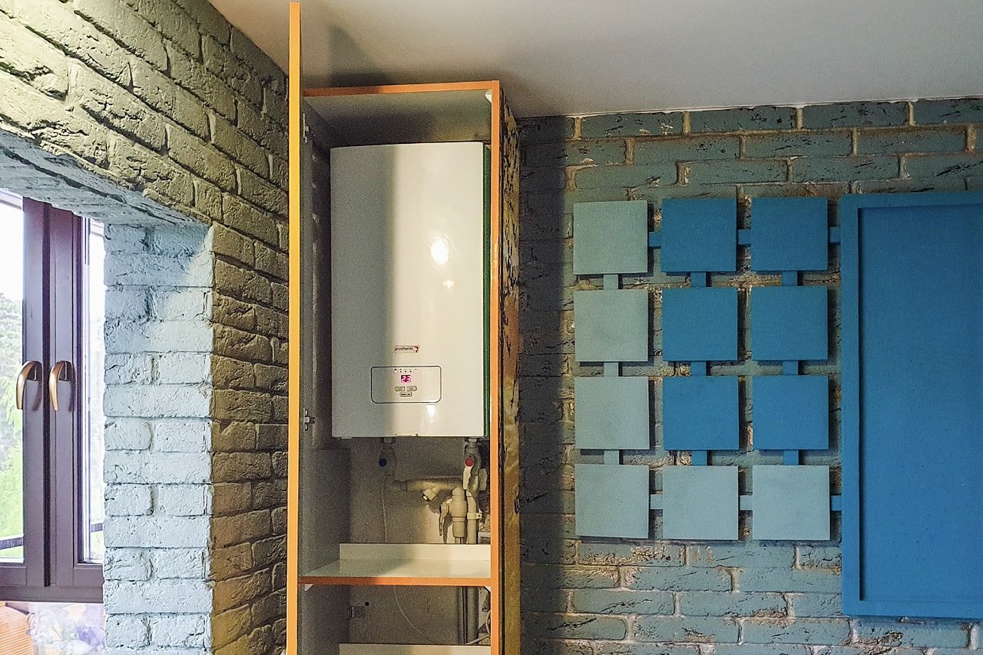 Wall-mounted combi boiler in a kitchen cupboard